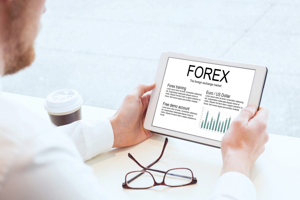 Man holding tablet with Forex written on it